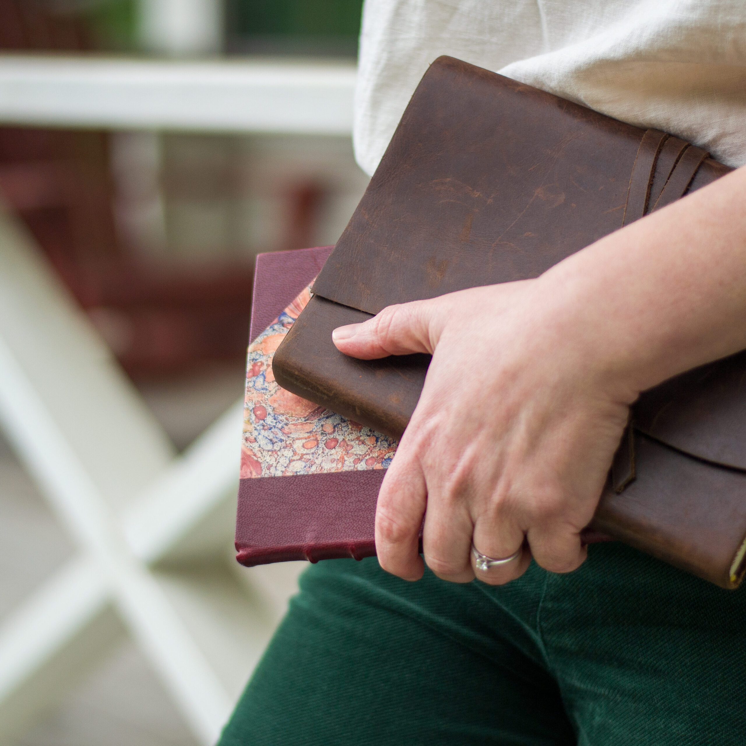Up close shot of Maureen carrying her journal and a collection of poetry